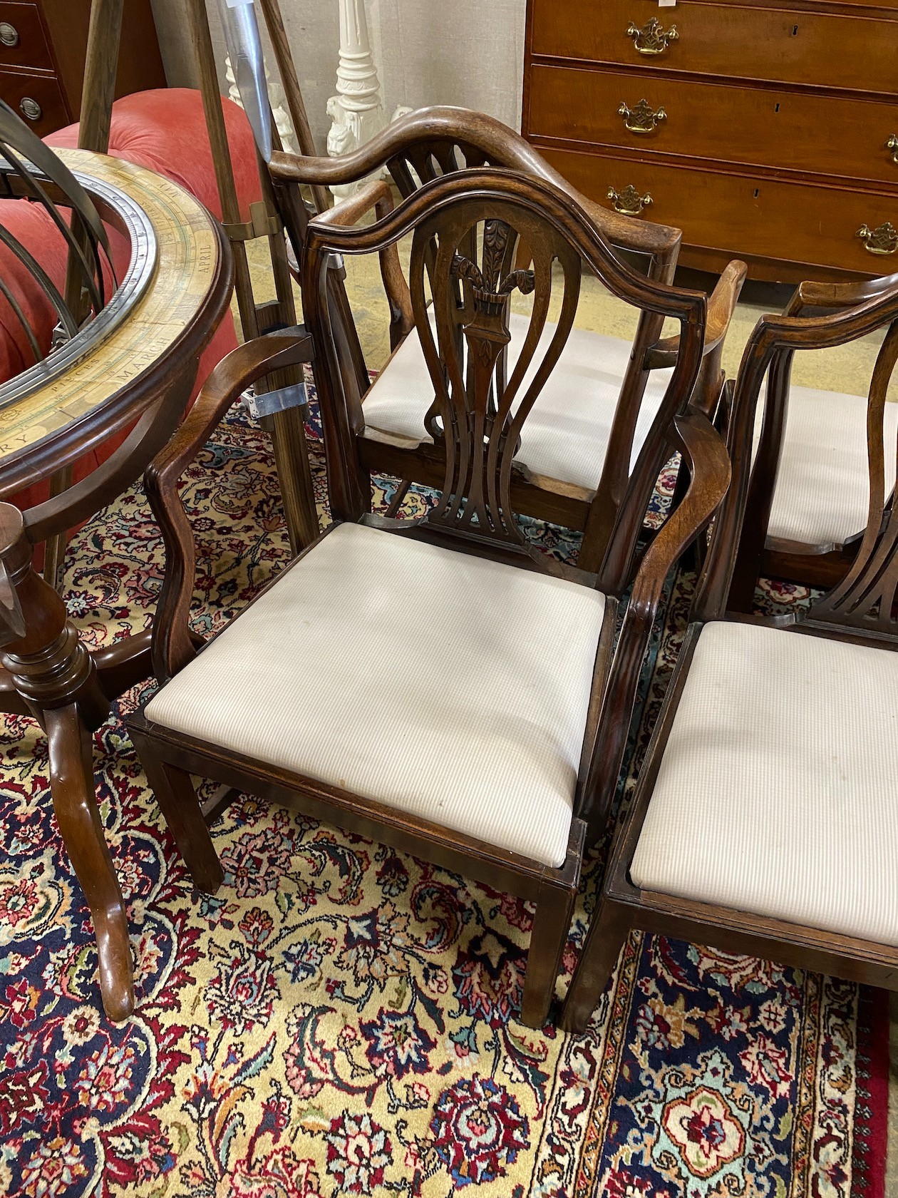 A set of seven George III style mahogany dining chairs, one with arms, together with a similar elbow chair